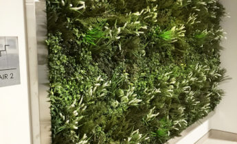 Artificial foliage install in condo hallway